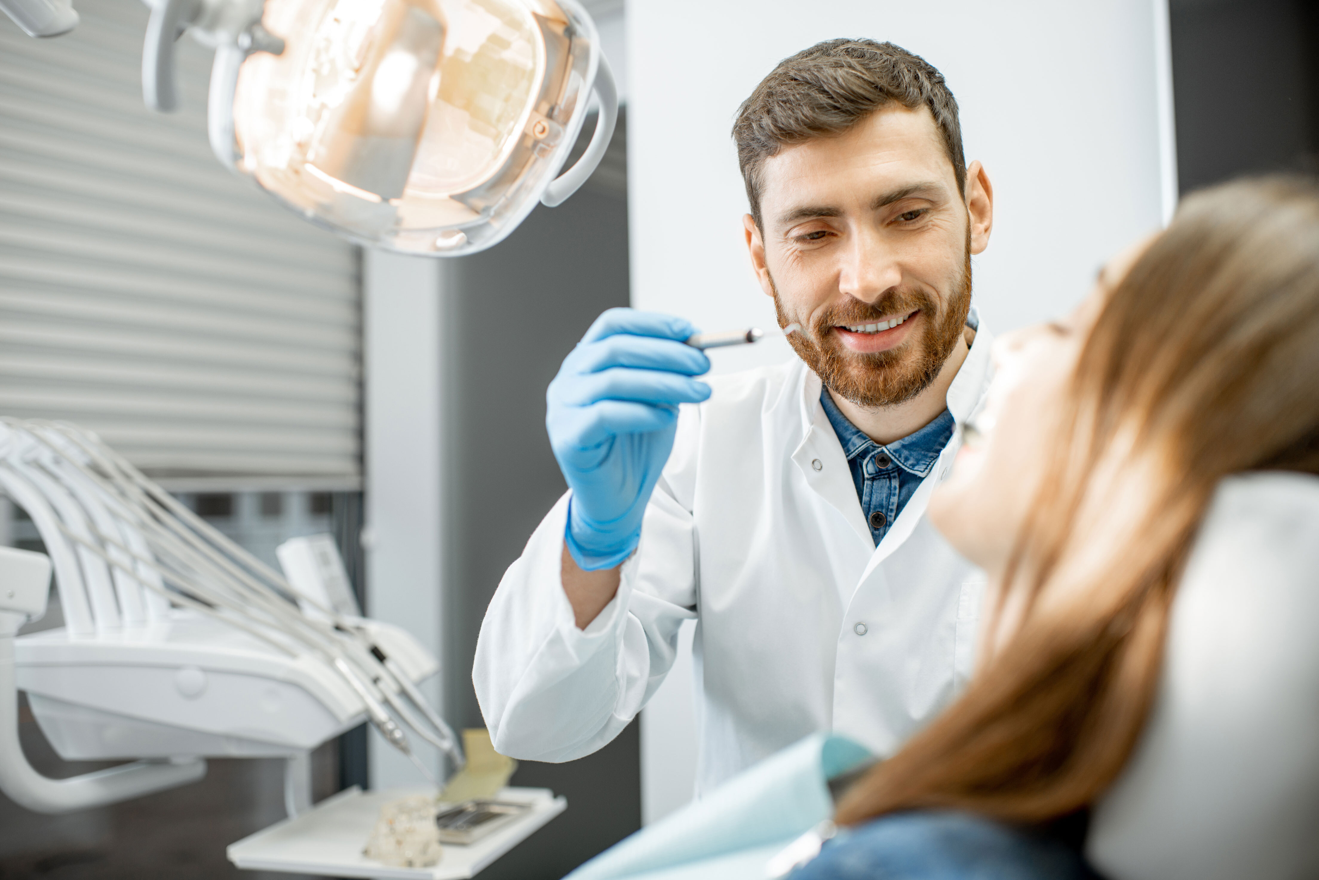 Inviting---dentist-giving-oral-cancer-screening